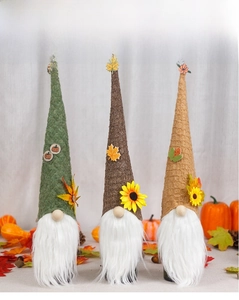 Detail of harvest gnome wine bottle covers with sunflowers and pumpkin decorations