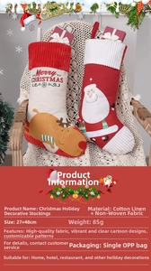 Detail view of large embroidered Christmas stockings with Santa and reindeer on a chair