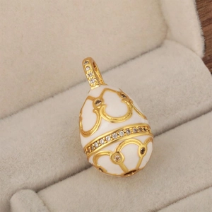 Macro view of a 18K gold-plated egg pendant with cubic zirconia in a jewelry box