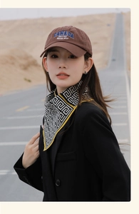 Detail of a fashion scarf with geometric patterns paired with a Canada embroidery cap