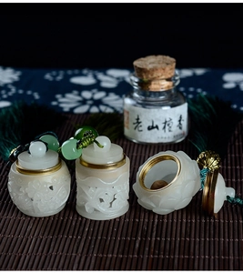 Detail of hand-carved sandalwood hollowed sachet diffuser with brass screw cap and tassels