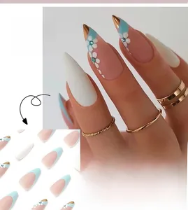 Detail of blue French stiletto press-on nails with floral patterns and small blue rhinestones
