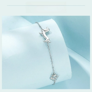 Close-up of S925 sterling silver bracelet featuring cute dachshund and paw print charms