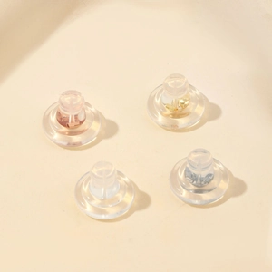 Macro shot of 18K gold and silver silicone earring backs with metal core inserts
