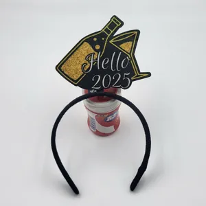 Close-up of Hello 2025 glitter headband with gold wine bottle and glass for New Year party