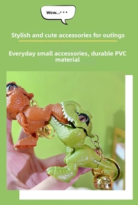 Close-up of green and orange PVC T-Rex dinosaur keychains with bells and metal rings