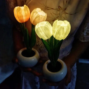 Macro detail of LED tulip night light with ceramic pot and warm glowing petals