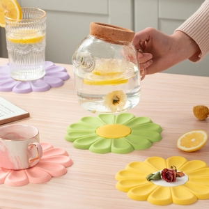 Daisy shaped silicone heat resistant placemats set in purple pink green and yellow
