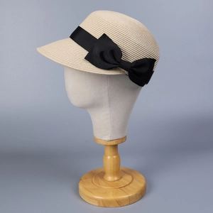 Dettaglio della trama del cappello di paglia beige con grande fiocco nero elegante