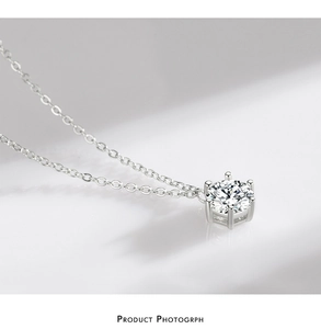 Macro shot of silver S925 necklace featuring a six-prong set brilliant round cut cubic zirconia