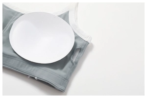 Detail of gray sports bra featuring removable pads and fine stitching craftsmanship