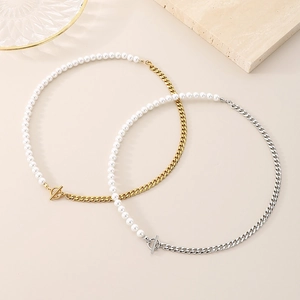 Close-up of gold and silver titanium Cuban chains with pearls and OT toggle clasps