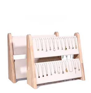 Double-tier wooden necklace display stands with beige padding for jewelry organization