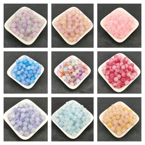 Macro shot of 8mm two-tone gradient glass beads in organized 3x3 white square trays