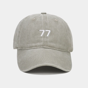 Détail de la broderie 77 blanche sur une casquette de baseball en coton délavé