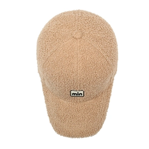 Minimalist beige teddy fleece baseball cap with min embroidery in a clean front view