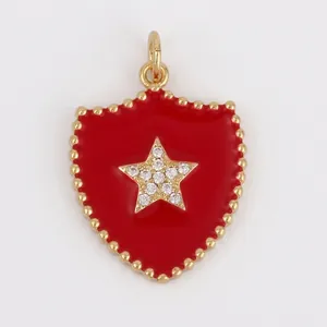Detailed view of a red enamel shield pendant with zircon star and 26mm x 18mm dimensions