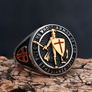 Detail of knight shield ring with red cross and Bible verse on tree bark background