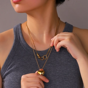 Layered 18K gold-plated stainless steel necklace with 3D heart pendant on model