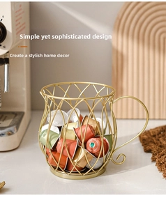 Close-up of golden iron coffee pod holder with elegant cup-shaped curve and handle