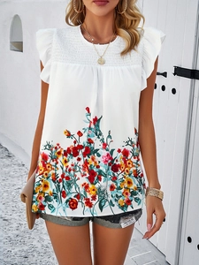 Close-up of sleeveless white floral top with smocked bodice and ruffled armhole detail