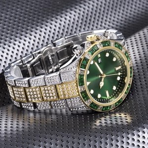 Macro shot of gold and silver luxury watch featuring a green sunray dial and diamond bezel