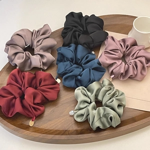Premium satin silk scrunchies set in 6 colors displayed on a classic wooden tray