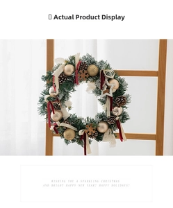 Close-up of pine needle wreath with champagne gold ornaments and red velvet ribbons