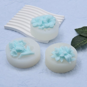 Detail of three floral silicone fondant molds showing intricate petal textures and patterns