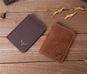 Close-up of vintage crazy horse leather card holders in brown and tan with bull logo