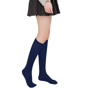 Detail view of dark blue knee-high socks with stripes paired with a pleated skirt