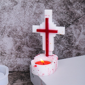 Detail of pixel art cross candle holder with resin base and red tealight candle