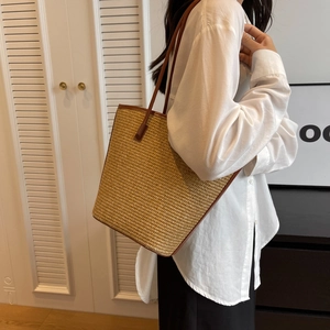 Fashionable striped straw tote bag with brown leather handles for beach and daily commute