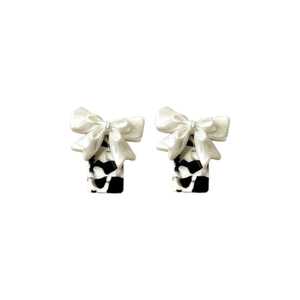 Chic bow earrings with cow print rectangular base and elegant white ribbon details