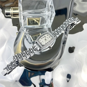 Detailed shot of tonneau emerald quartz watch with silver strap and rhinestone bezel