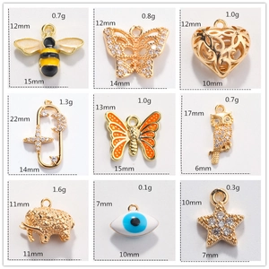 Macro detail showing sizes and weights of various gold DIY jewelry pendants for crafting
