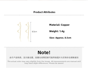 Detail view of gold wavy threader earrings in copper with 8.5cm length and 1.4g weight