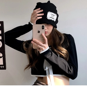 Women's black knitted cat ear hat with white contrast drawstring and branded patch