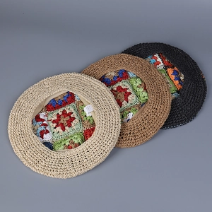 Top view of hand-crocheted berets featuring colorful square patchwork patterns