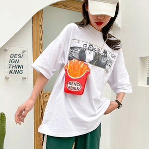 Detail of creative french fries crossbody bag with golden chain strap on a white shirt
