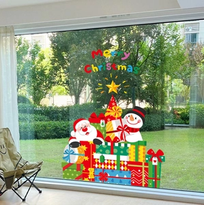 Christmas window decals with Santa and snowman stickers on glass window overlooking a garden