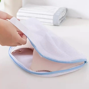Mesh laundry bag for bras with blue zipper showing inner bra placement for machine protection