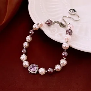 Vintage pearl bracelet featuring a square purple zircon center stone and silver clasp