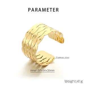 Detail shot of golden stainless steel wide cuff bracelet with layered leaf pattern texture