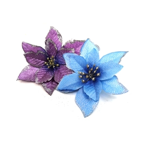 Detail view of blue and purple artificial poinsettia flowers with silver glitter edges