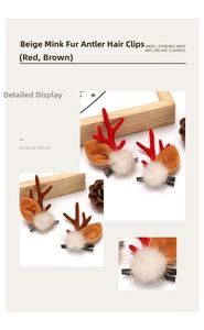 Close-up of reindeer antler hair clips with white faux fur balls for Christmas decor