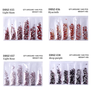 Detail view of colorful flatback crystals in storage grids with labels and quantity info