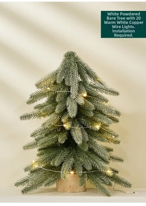 Detail of mini frosted Christmas tree with warm LED lights and a rustic wooden base