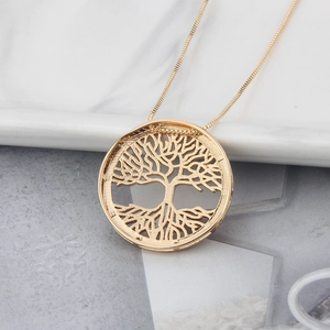 Macro shot of gold-plated Tree of Life pendant necklace with intricate hollowed branches