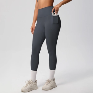 Detail of high waisted yoga leggings featuring side pocket with smartphone storage
